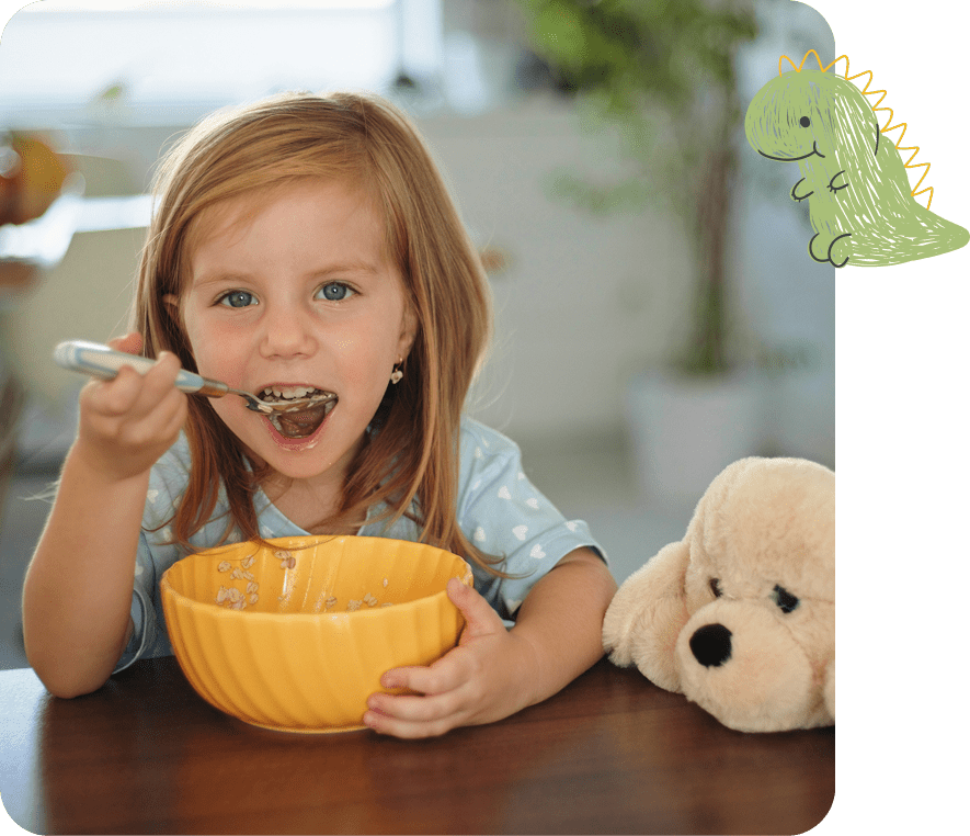 Child enjoying breakfast with stuffed toy